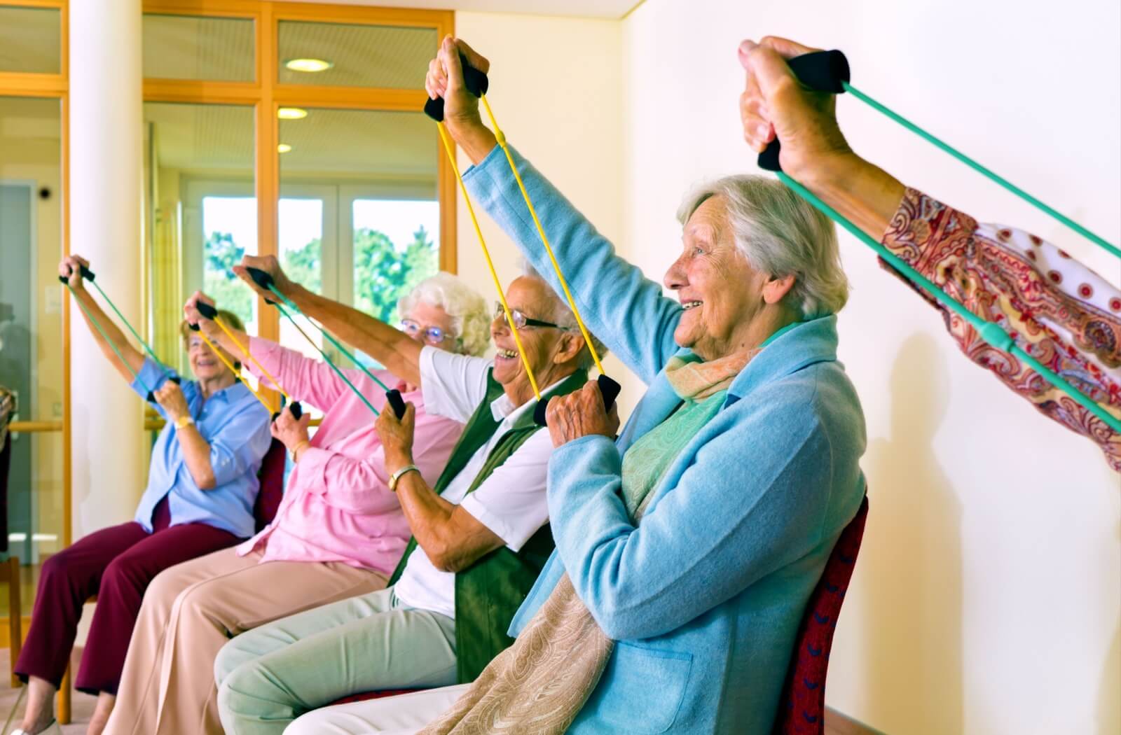 A group of seniors participate in an exercise class together.